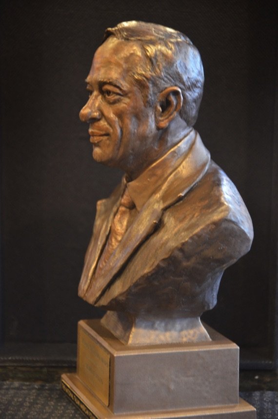 A bust of a man wearing a suit and tie.