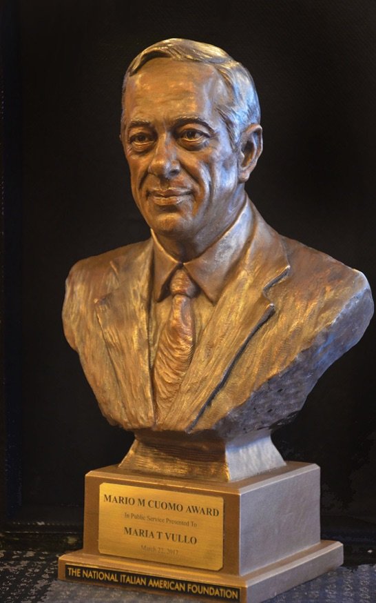 A bust of a man wearing a suit and tie.