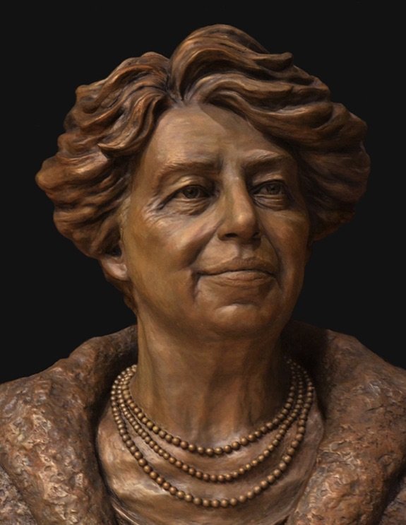 A statue of an older woman wearing pearls.