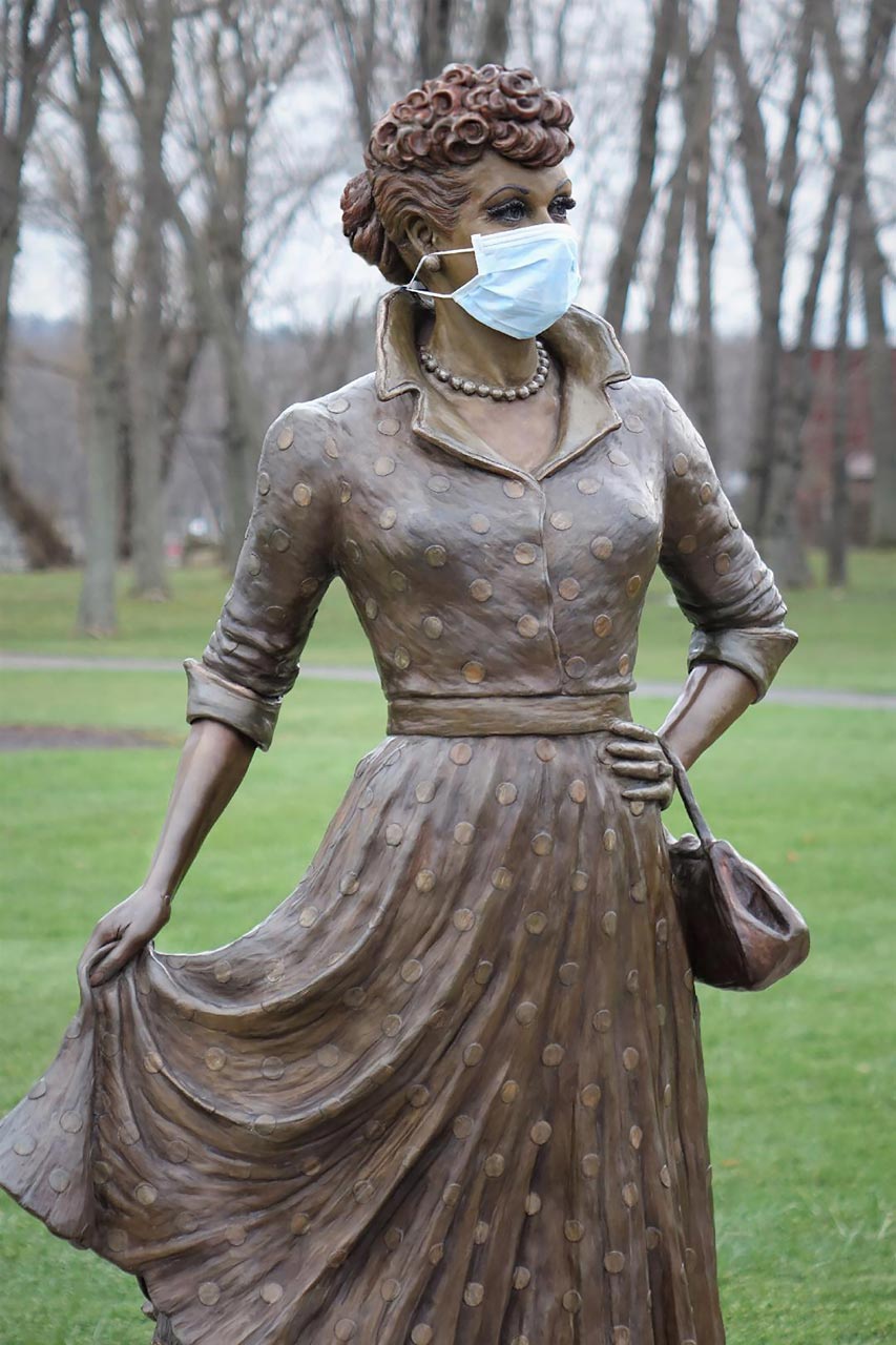 A statue of a woman wearing a mask.